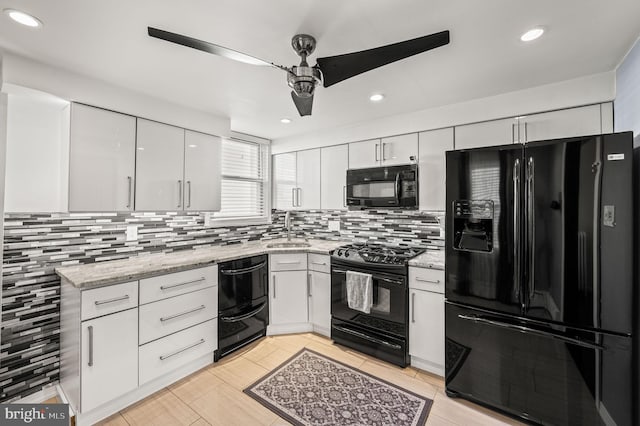 kitchen with sink, black appliances, white cabinets, and ceiling fan