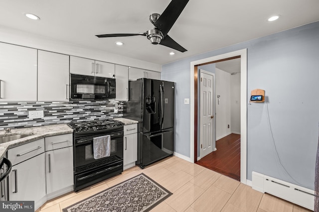 kitchen with ceiling fan, a baseboard heating unit, tasteful backsplash, black appliances, and white cabinets