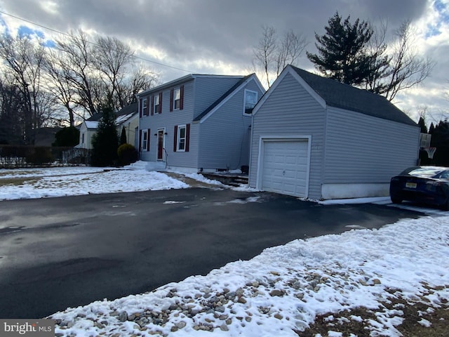 view of snow covered exterior featuring a garage