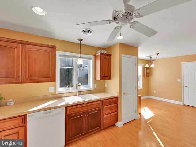 kitchen featuring pendant lighting, sink, ceiling fan, white dishwasher, and light hardwood / wood-style floors