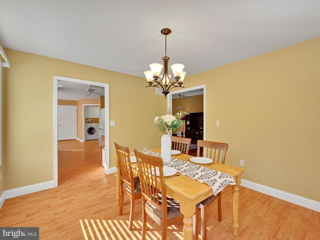 dining room featuring hardwood / wood-style floors and ceiling fan with notable chandelier