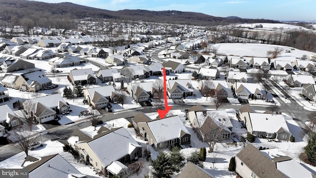 snowy aerial view featuring a mountain view