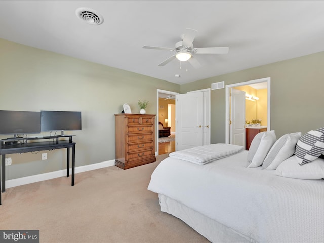 carpeted bedroom with ceiling fan and ensuite bathroom