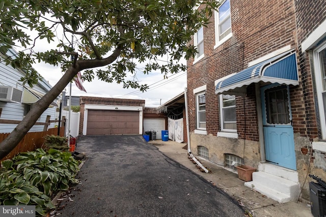 view of property exterior with a garage and an outdoor structure