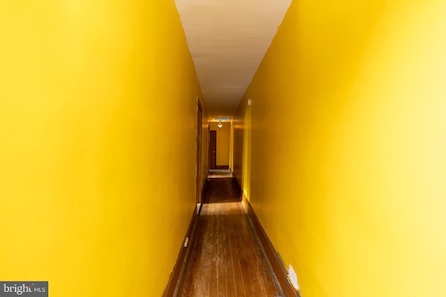 hall with dark hardwood / wood-style floors