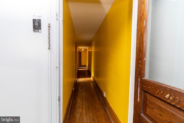 corridor with hardwood / wood-style flooring