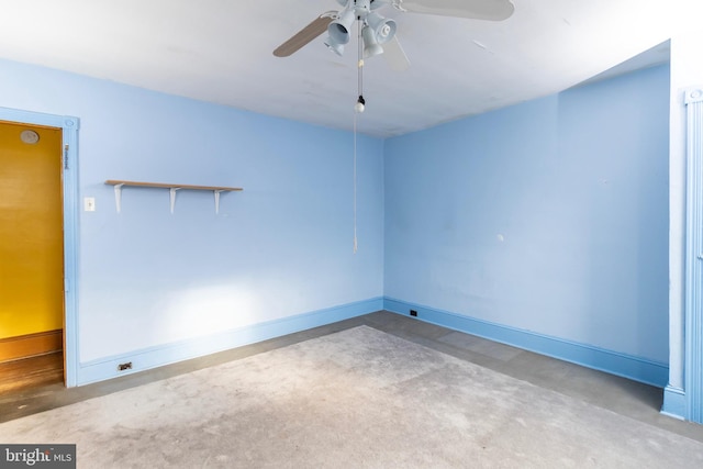 carpeted spare room with ceiling fan