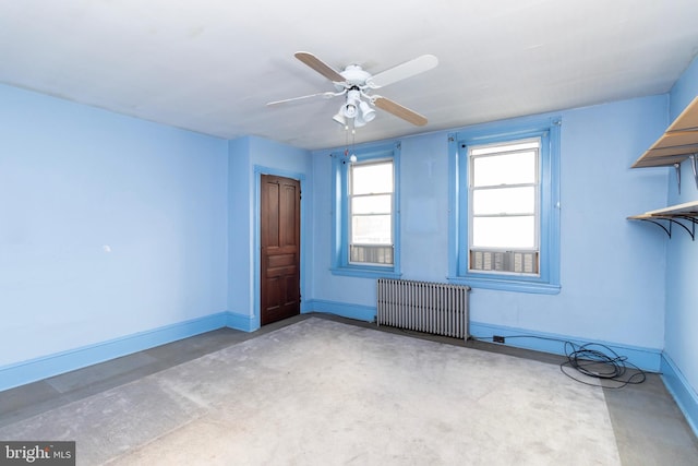 unfurnished room with radiator and ceiling fan