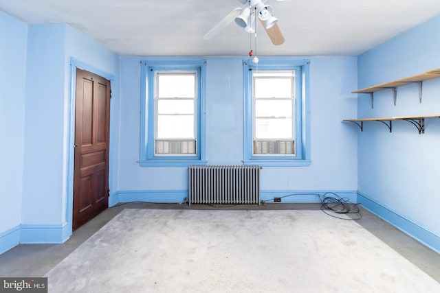 spare room featuring radiator and ceiling fan