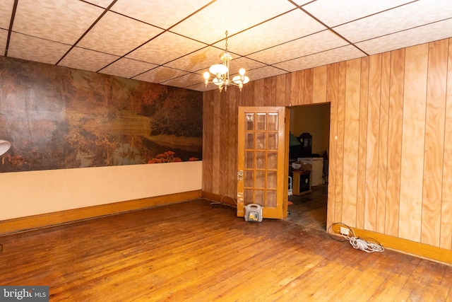 unfurnished room featuring hardwood / wood-style floors and a notable chandelier