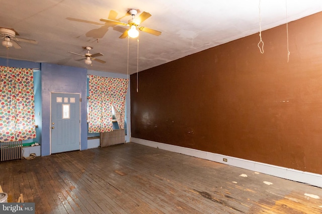 interior space featuring wood-type flooring and radiator heating unit