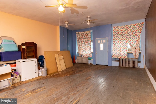 miscellaneous room with radiator and wood-type flooring