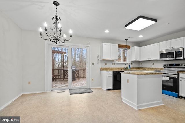 kitchen featuring stainless steel appliances, a kitchen island, pendant lighting, and white cabinets