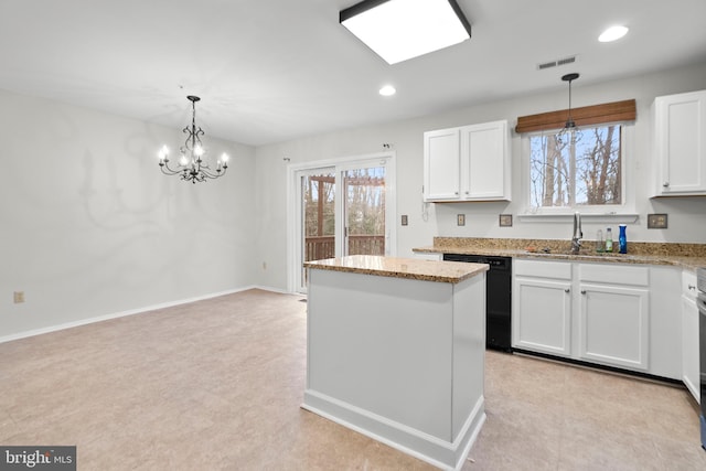 kitchen with hanging light fixtures, a kitchen island, sink, and white cabinets