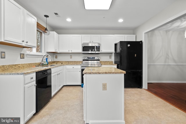 kitchen with a kitchen island, sink, white cabinets, light stone counters, and black appliances