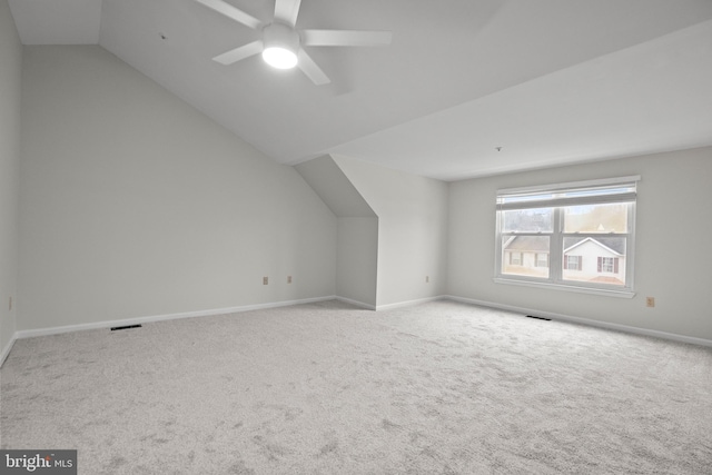 bonus room featuring ceiling fan, vaulted ceiling, and light carpet