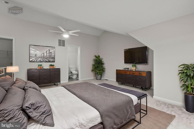 carpeted bedroom featuring ensuite bathroom, lofted ceiling, and ceiling fan