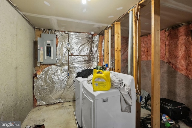 utility room featuring electric panel and independent washer and dryer