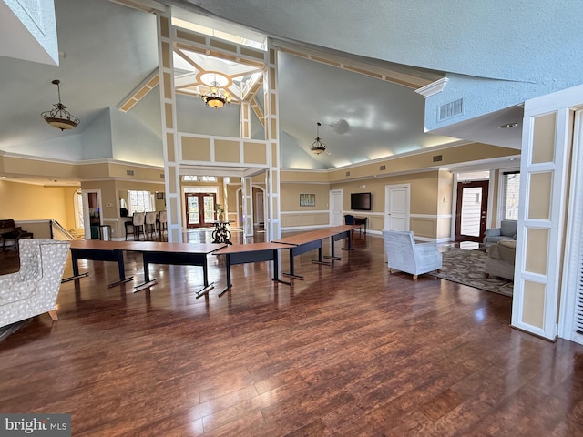 playroom with dark hardwood / wood-style flooring, french doors, a healthy amount of sunlight, and an inviting chandelier