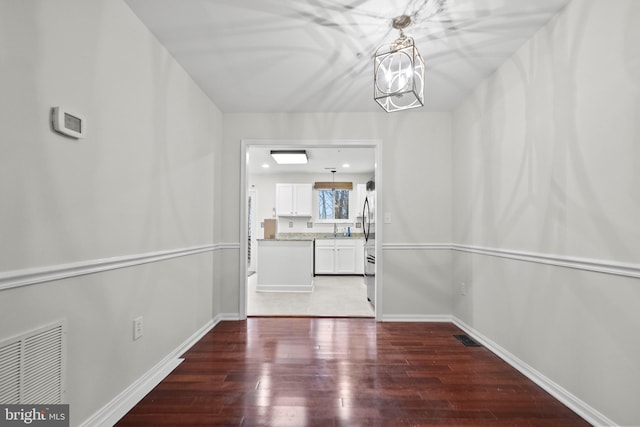 interior space featuring sink, a chandelier, and dark hardwood / wood-style flooring