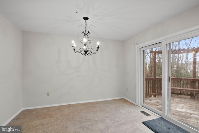 unfurnished room with an inviting chandelier and carpet flooring