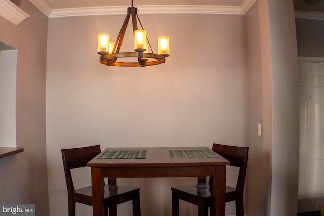 dining area with crown molding and a chandelier