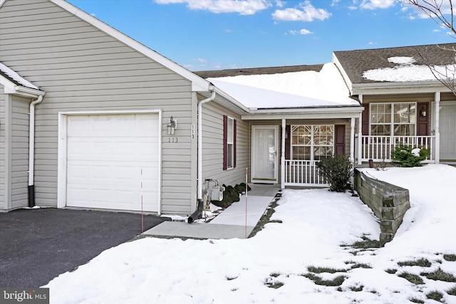 view of front of home with a garage and a porch