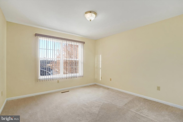 empty room featuring light carpet