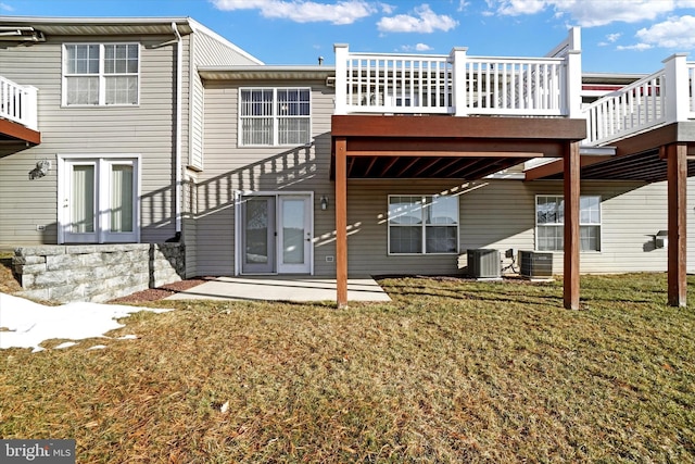 rear view of house featuring central AC, a yard, and a patio area