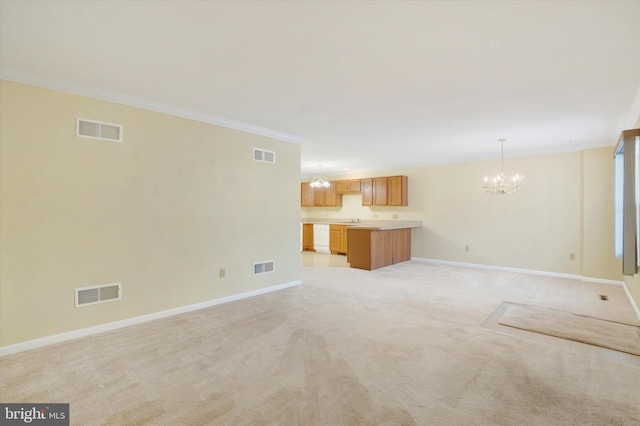 unfurnished living room with light carpet, sink, ornamental molding, and a chandelier