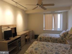 bedroom with track lighting and ceiling fan