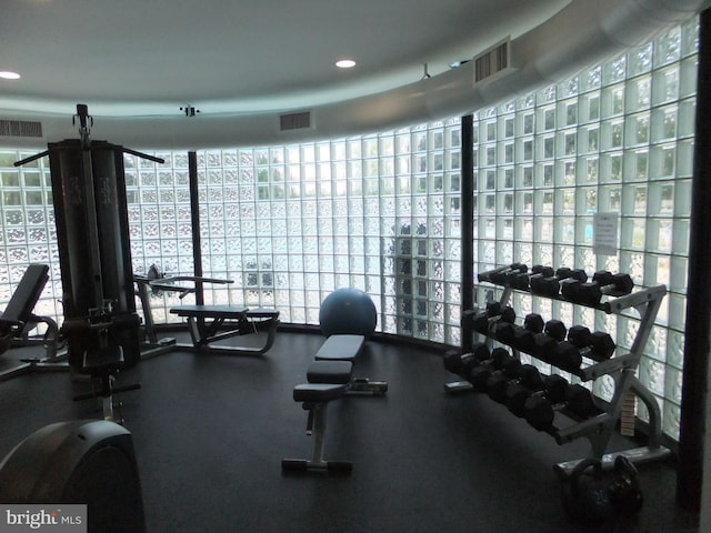 gym with a wall of windows