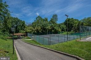 view of sport court with a yard