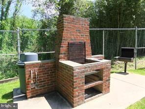 view of patio featuring an outdoor brick fireplace