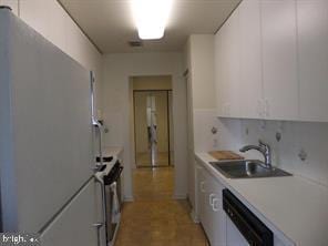 kitchen with electric stove, sink, refrigerator, white cabinetry, and white dishwasher