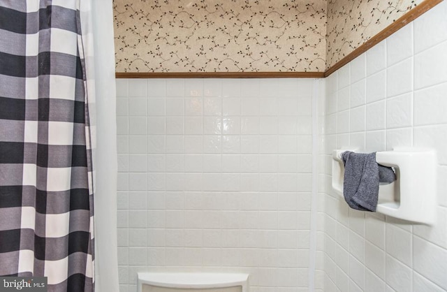 bathroom with tile walls