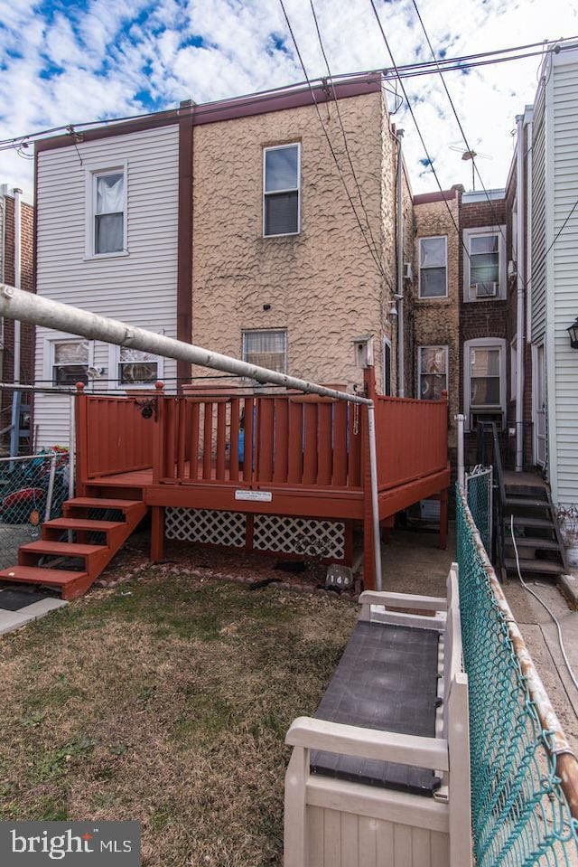 rear view of house with a wooden deck