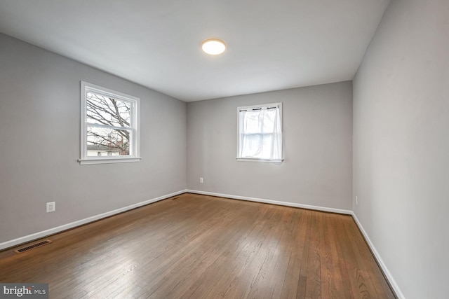 unfurnished room featuring hardwood / wood-style floors