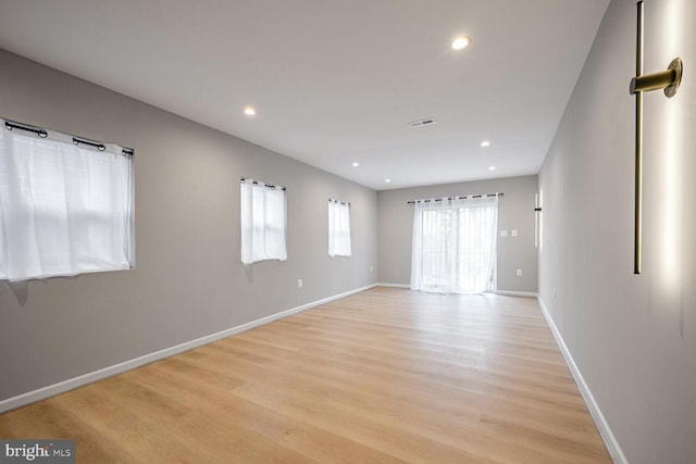 spare room featuring light wood-type flooring