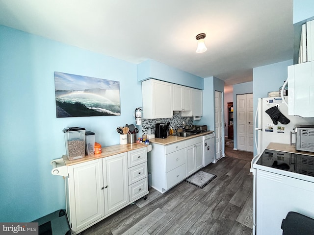 kitchen with decorative backsplash, white appliances, and white cabinets