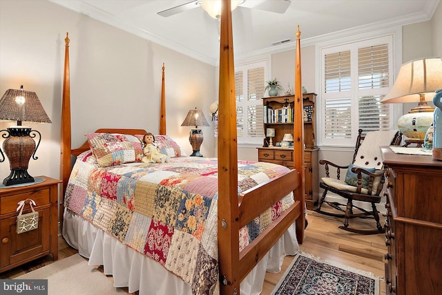 bedroom with ornamental molding, ceiling fan, and light hardwood / wood-style flooring