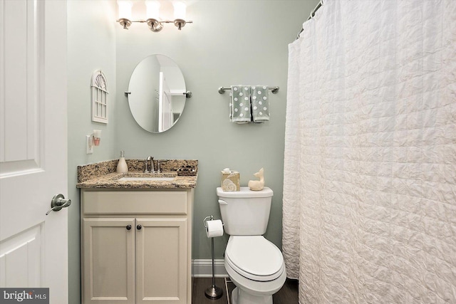 bathroom featuring vanity, hardwood / wood-style floors, and toilet