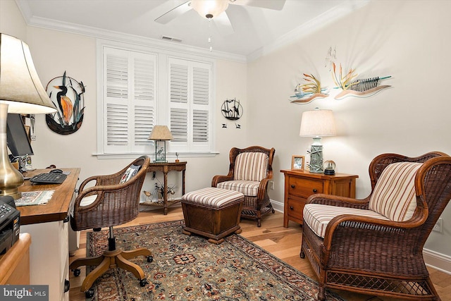 home office featuring hardwood / wood-style floors, ornamental molding, and ceiling fan