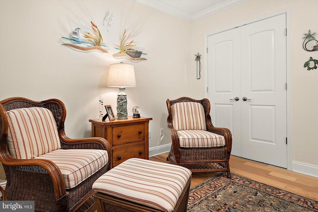 sitting room featuring hardwood / wood-style flooring and ornamental molding