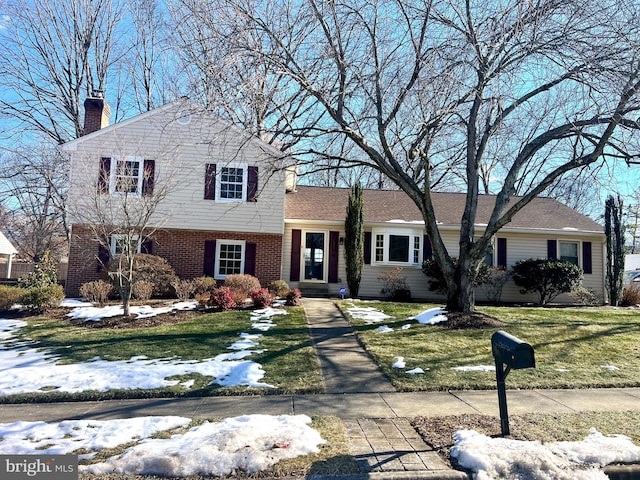 split level home featuring a yard