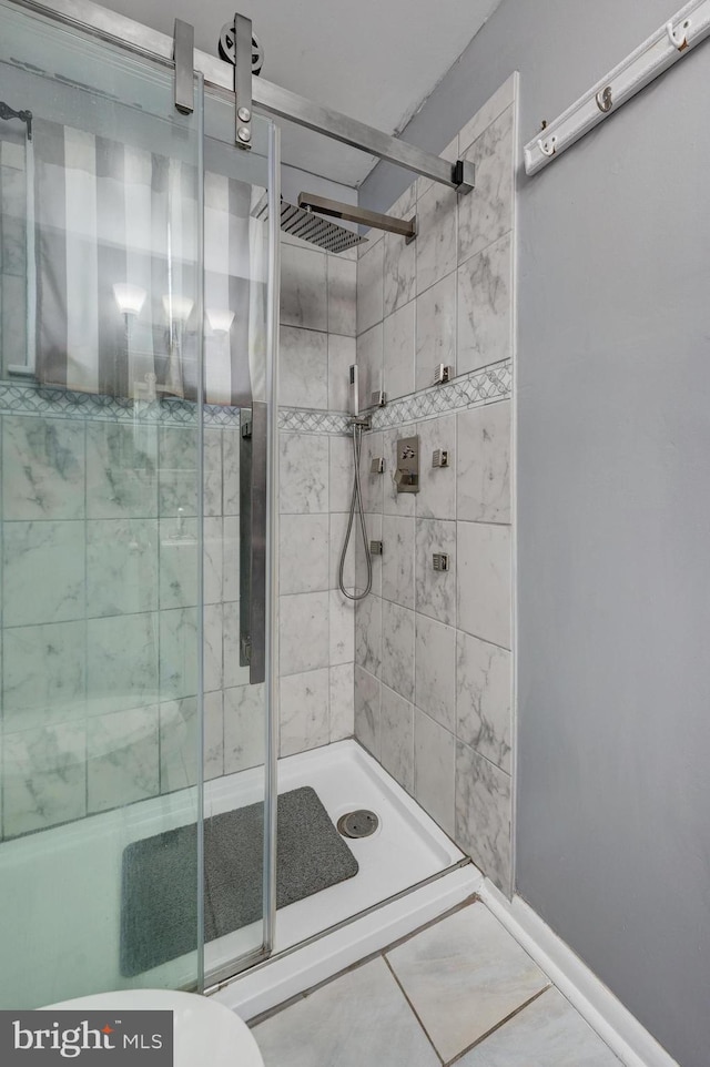 bathroom with walk in shower, toilet, and tile patterned flooring