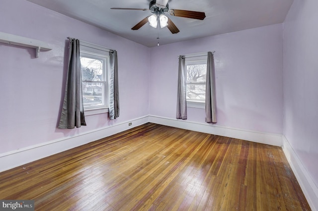 unfurnished room with hardwood / wood-style floors, plenty of natural light, and ceiling fan