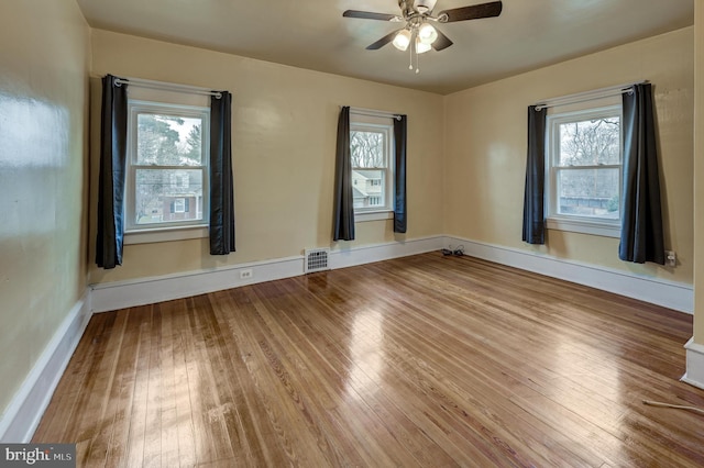 spare room with hardwood / wood-style flooring and ceiling fan