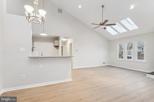 unfurnished living room featuring high vaulted ceiling, recessed lighting, light wood-style flooring, and baseboards