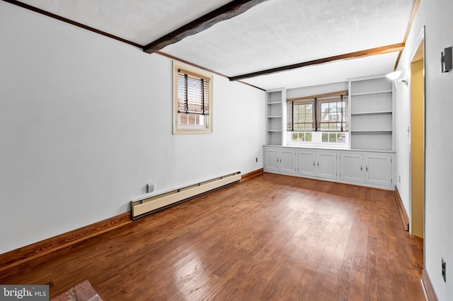 unfurnished room featuring beam ceiling, hardwood / wood-style floors, built in features, and baseboard heating